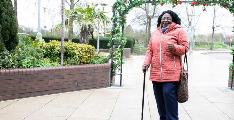 Woman smiling using walking aid