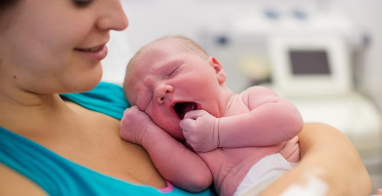 A women holding a newborn 