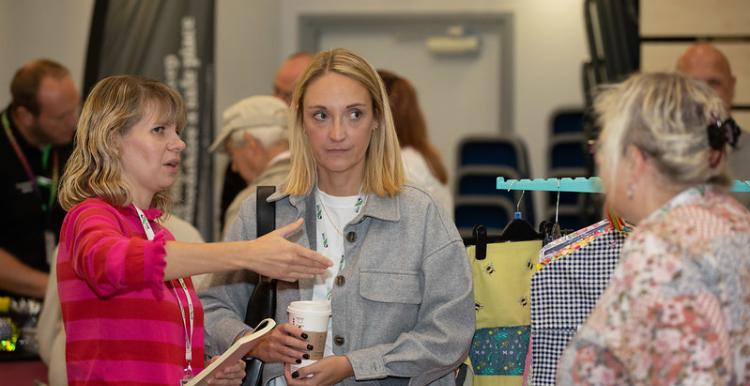 Three women talking at an event