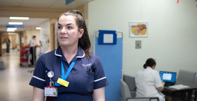 A female clinician in a hospital corridor 