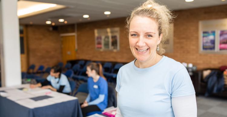 Blonde haired woman wearing a blue top Blonde haired woman wearing a blue top