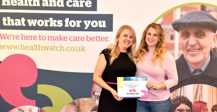 Two blonde women receiving a Healthwatch Network Award