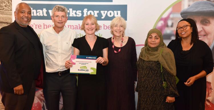 Six members of local Healthwatch holding up a runners up certificate from the Healthwatch network awards. 
