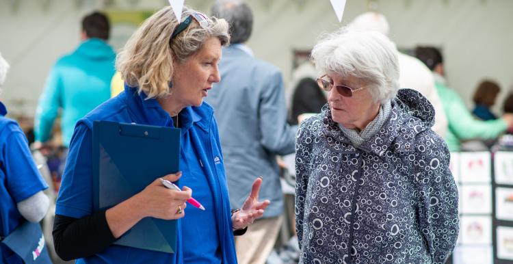Two women talking at a county show