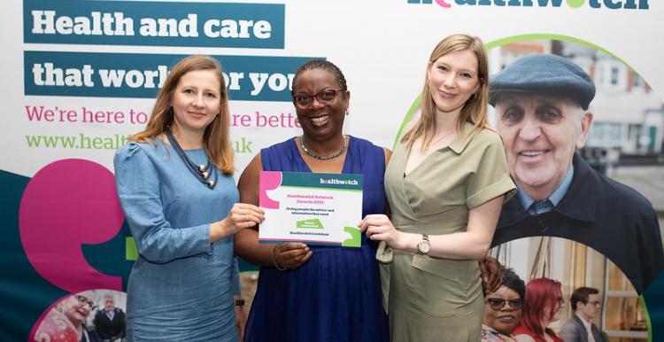 Three women holding a certificate