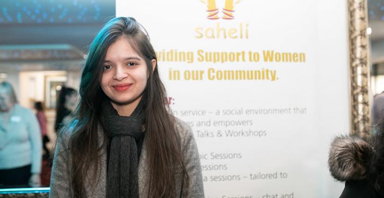 Young woman in front of a charity banner Young woman in front of a charity banner