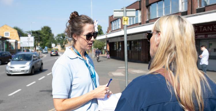 Two Healthwatch staff fill in a form.