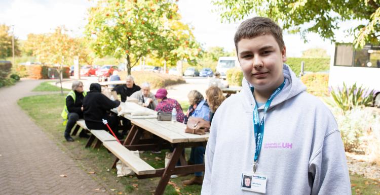 Young Healthwatch volunteer standing outside
