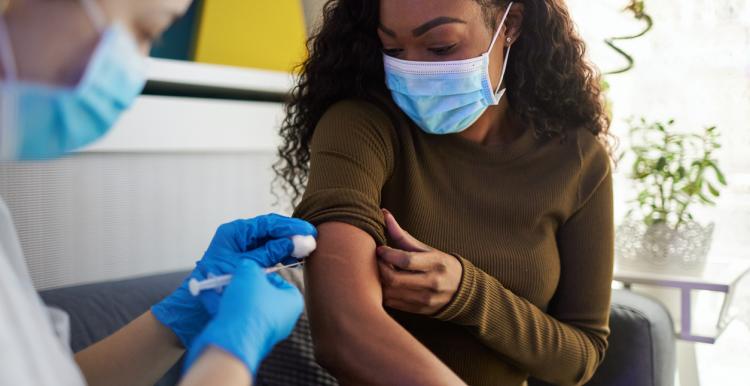 A woman gets her COVID-19 vaccine A woman gets her COVID-19 vaccine