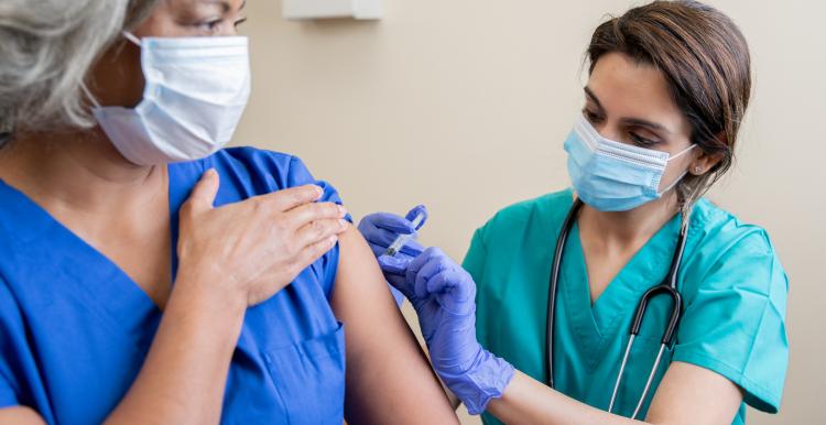 A woman receiving her vaccine