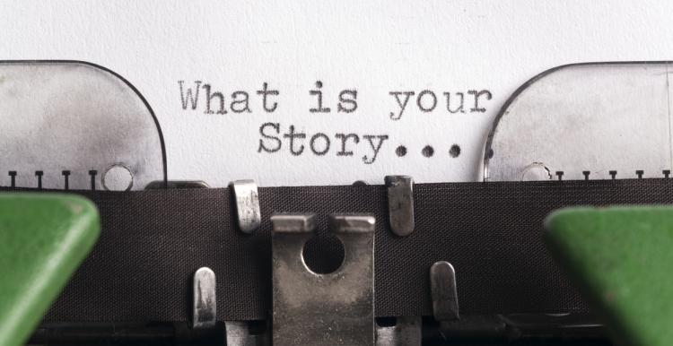 Typewriter with 'What is your story' written on the page
