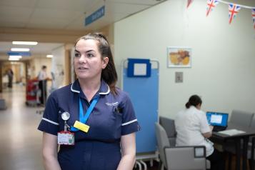 A female clinician in a hospital corridor 