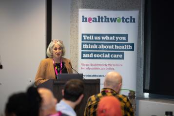 Healthwatch representative speaking at an event to groups of people