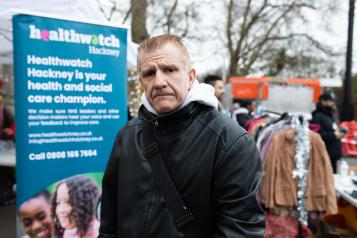 Person standing in front of Healthwatch banner 