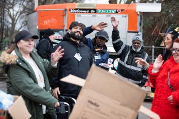Group of people waving and smiling at the camera