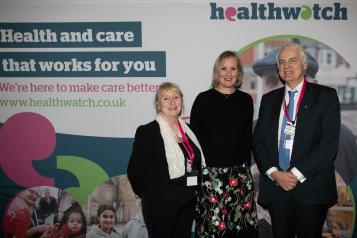 Imelda Remond, Caroline Dineage and Sir Robert Francis in from of Healthwatch sign.