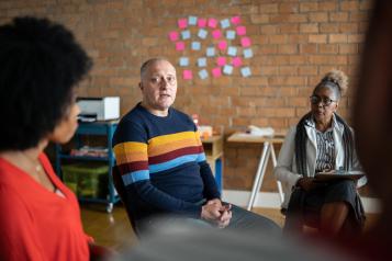 Mature man talking in group