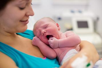 A women holding a newborn 